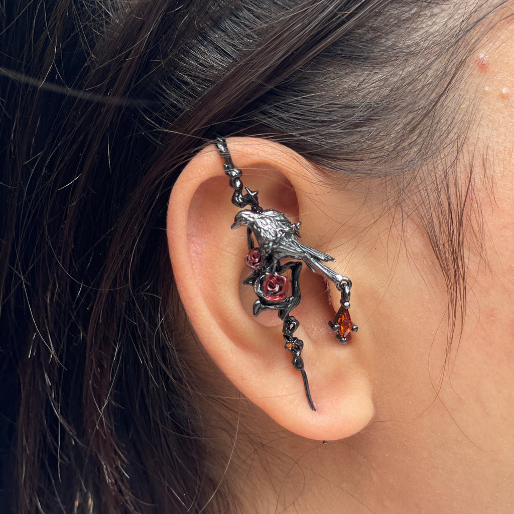 Close-up of an ear with a detailed dragon-shaped earring.