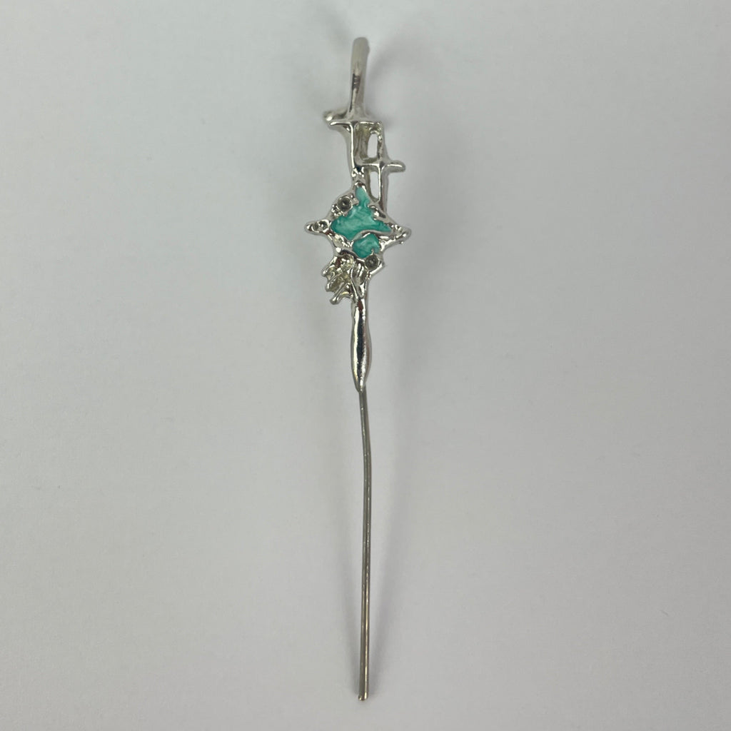 Silver bracelet with a central gemstone on a light gray background