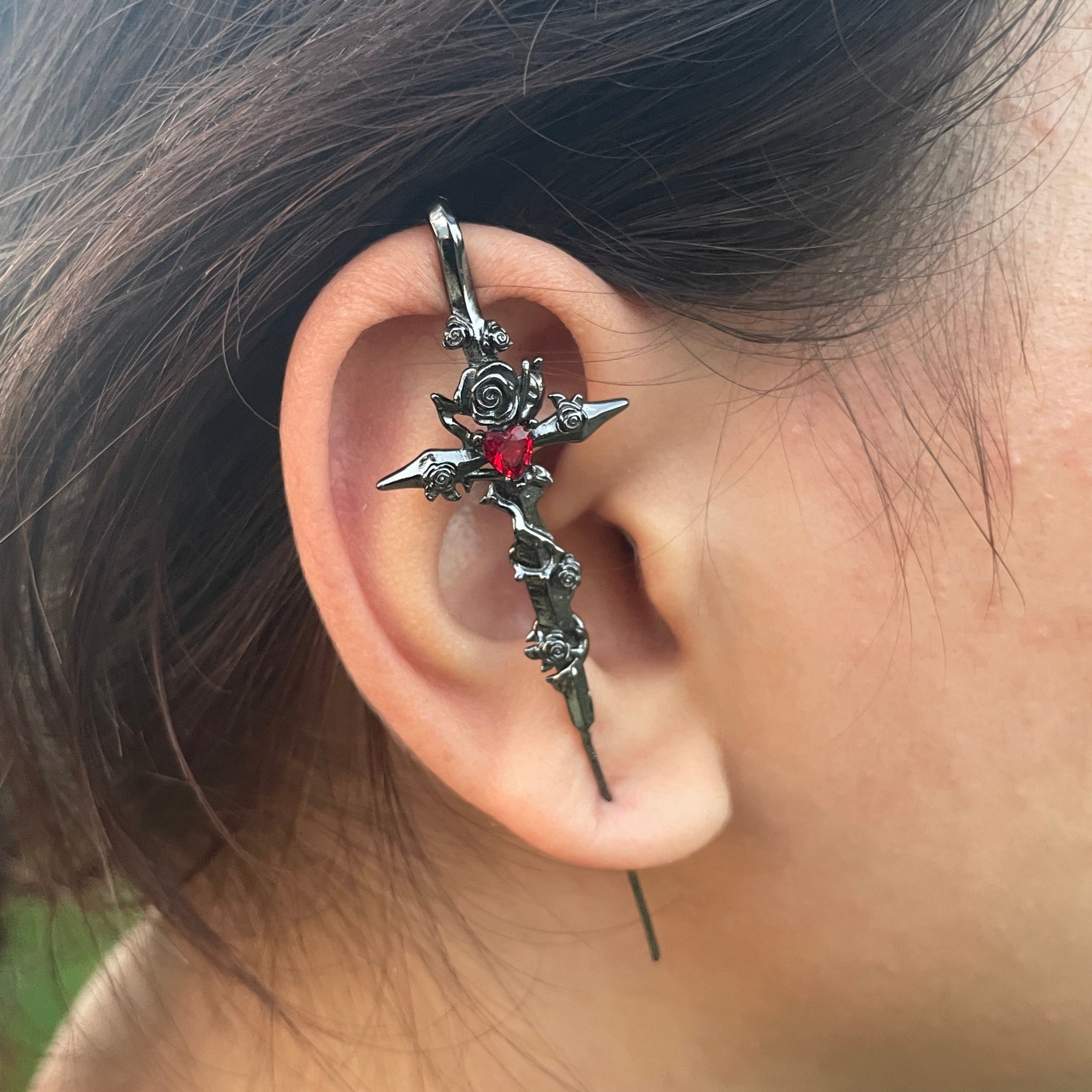 Close-up of an ear with a decorative earring, blurred background