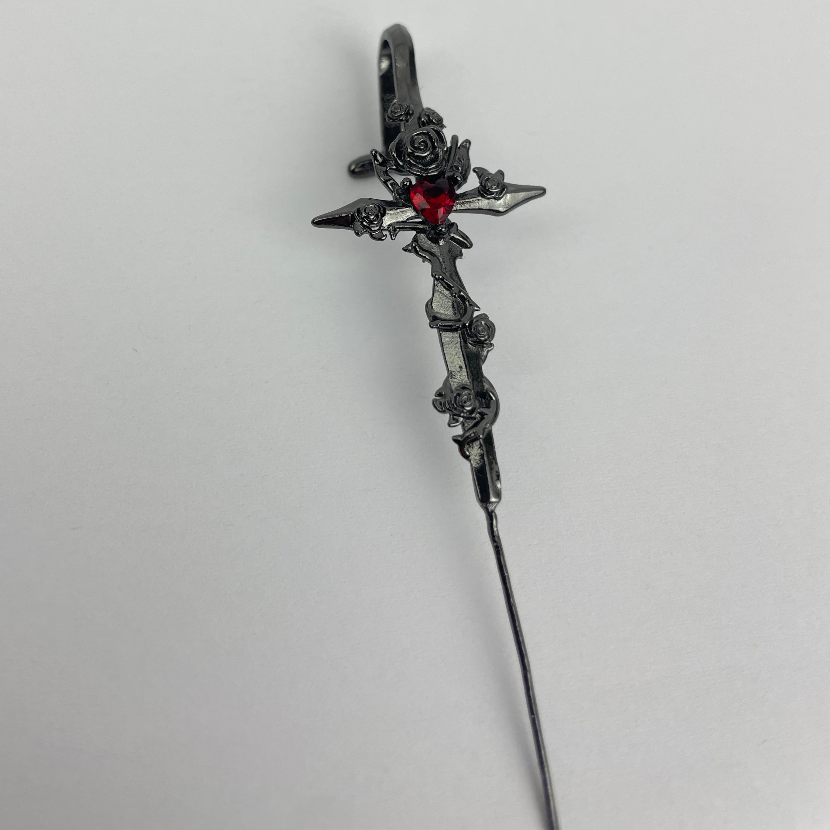 Decorative hairpin with intricate design on a light gray background