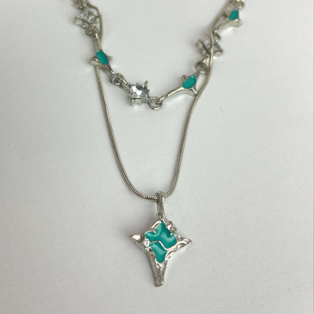 Silver necklace with turquoise stones on a white background