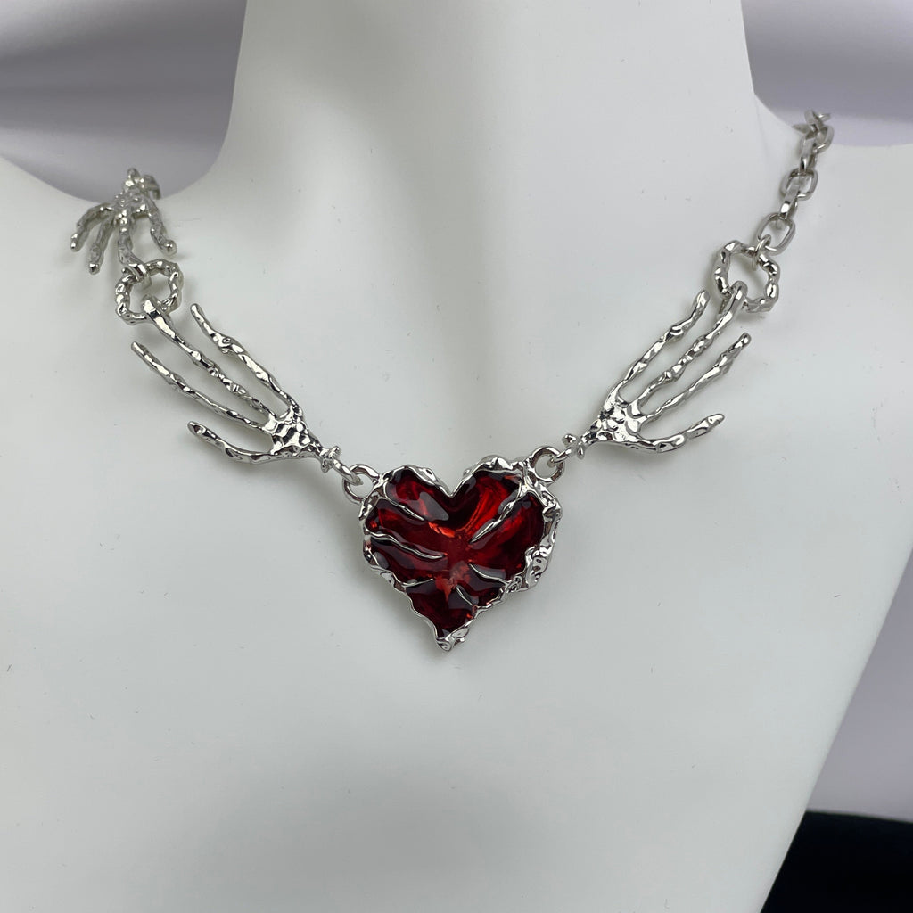 Necklace with a red heart pendant on a mannequin