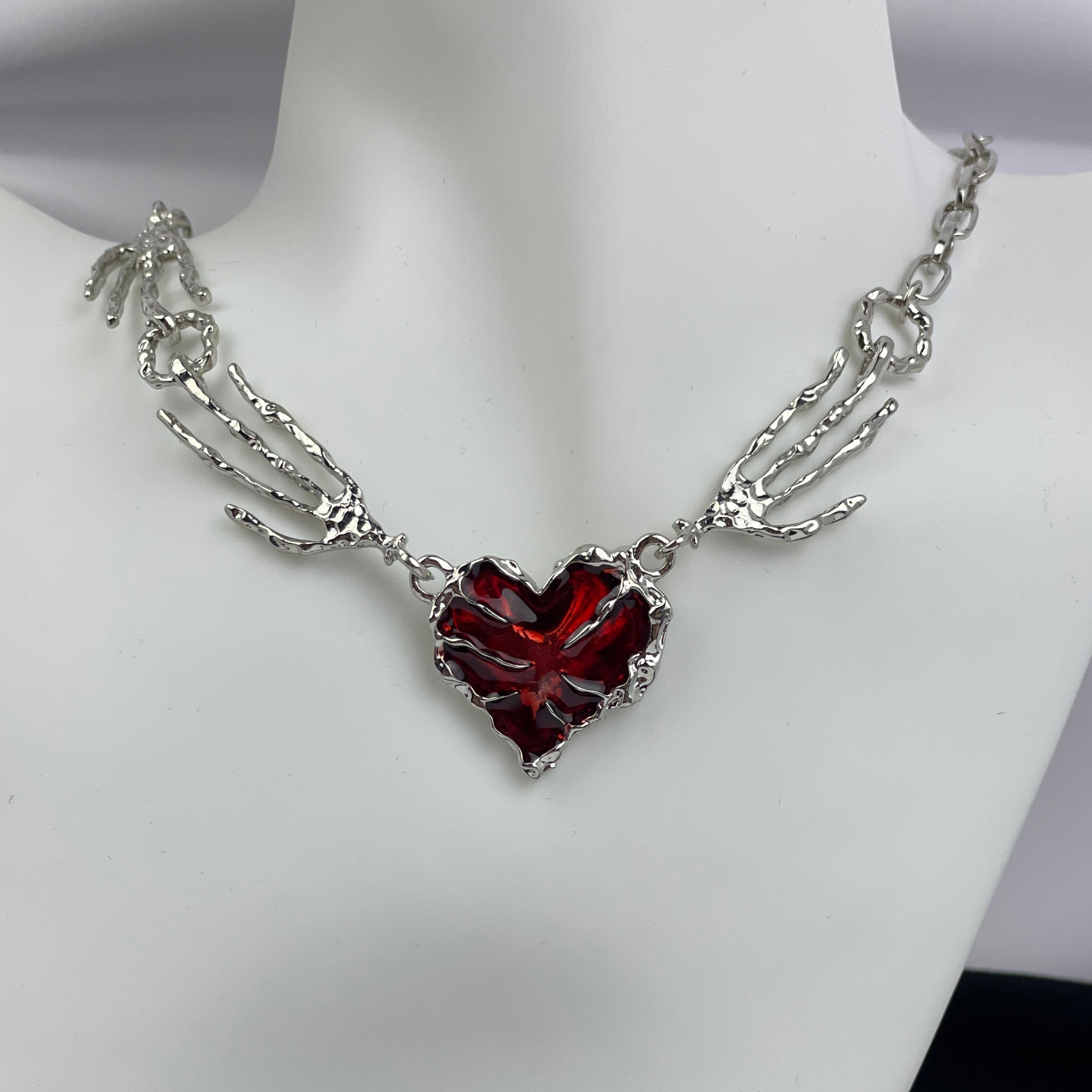 Necklace with a red heart pendant on a mannequin